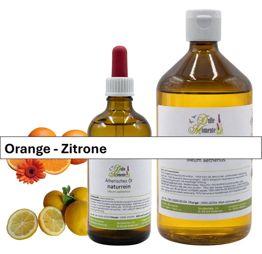 Große und kleine Flasche der ätherischen Ölmischung Orange-Zitrone mit Orangen und Zitronen